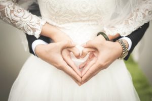 man and woman at a wedding with hands forming two hearts, danish marriage