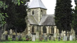 Danish cemetery with headstones and church in background