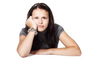 girl with a bored look on her face and white background