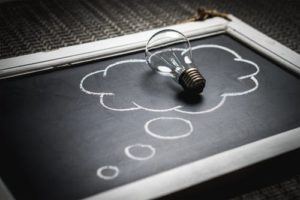 light bulb laying on chalkboard 