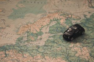 black toy car on vintage map of Denmark
