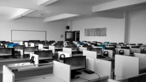 computers in cubicles against a black and white backdrop