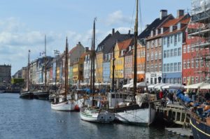 Copenhagen City from the water looking at colorful houses on the water with boats in front