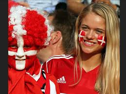 Danish people wearing the Danish flag painted on faces at a sporting event