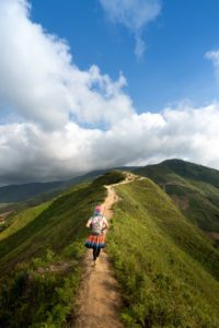 woman waking on mountain top on a sunny day